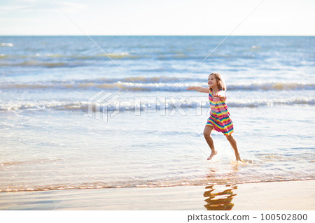 Kids play on tropical beach. Sand and water toy. Kids play on tropical beach. Sand and water toy. 100502800