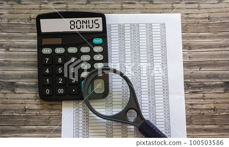 Word BONUS on the display of a calculator on financial documents. Word BONUS on the display of a calculator on financial documents. 100503586