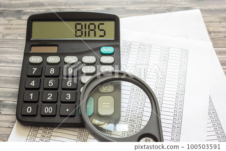 Bias, text on a calculator with documents and a magnifying glass on them. Business, finance Bias, text on a calculator with documents and a magnifying glass on them. Business, finance 100503591