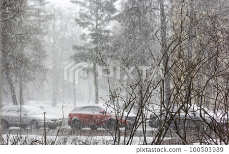 View of an empty snow-covered city street during a snowfall. Snow road. Fresh white snow  100503989