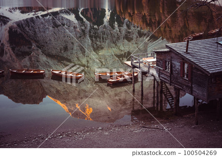 Wooden boats near old pier in clear water 100504269