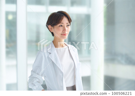 Smiling female doctor in a white coat at the hospital Smiling female doctor in a white coat at the hospital 100506221