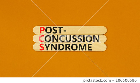 PCS post-concussion syndrome symbol. Concept words PCS post-concussion syndrome on wooden stick on a beautiful orange table orange background. Medical PCS post-concussion syndrome concept. Copy space. 100506596