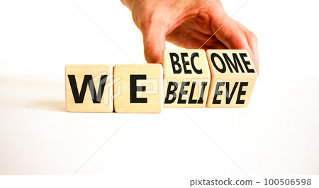 We become or believe symbol. Concept word We believe We become on wooden cubes. Beautiful white table white background. Businessman hand. Business we become or believe concept. Copy space. 100506598