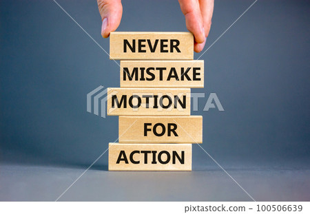 Mistake or action symbol. Concept words Never mistake motion for action on wooden blocks. Businessman hand. Beautiful grey table grey background. Business mistake or action concept. Copy space. Mistake or action symbol. Concept words Never mistake motion for action on wooden blocks. Businessman hand. Beautiful grey table grey background. Business mistake or action concept. Copy space. 100506639