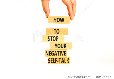 Stop negative self-talk symbol. Concept words Stop to flip your negative self-talk typed on blocks. Psychologist hand. Beautiful white background. Psychological negative self-talk concept. Copy space. Stop negative self-talk symbol. Concept words Stop to flip your negative self-talk typed on blocks. Psychologist hand. Beautiful white background. Psychological negative self-talk concept. Copy space. 100506646