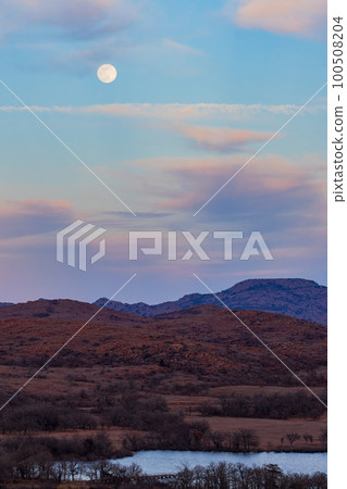 Sunset landscape with a full moon in Wichita Mountains National Wildlife Refuge 100508204