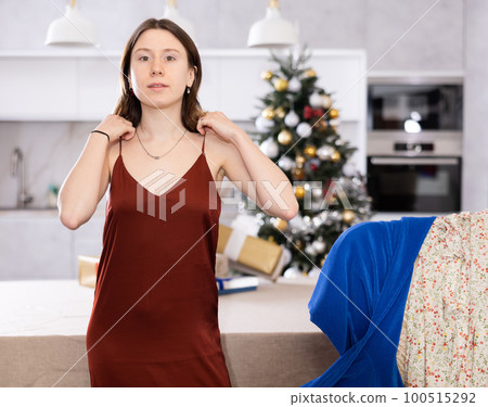 Young woman poses in a new festive dress 100515292