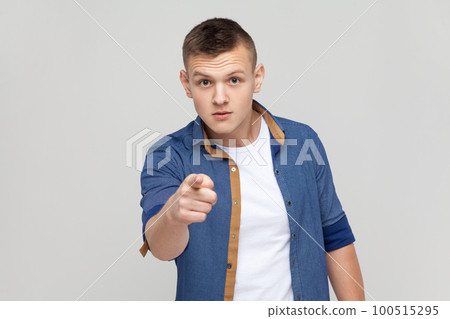 Are you ready. Portrait of handsome teenager boy wearing blue shirt pointing finger at camera choosing you, scolding and forcing to move on. Indoor studio shot isolated on gray background. Are you ready. Portrait of handsome teenager boy wearing blue shirt pointing finger at camera choosing you, scolding and forcing to move on. Indoor studio shot isolated on gray background. 100515295