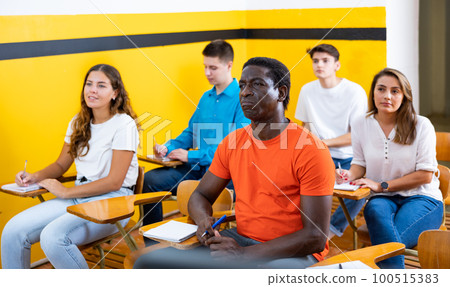 Men and women studying in taxi driving school Men and women studying in taxi driving school 100515383