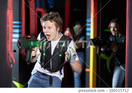 Young guy playing lasertag in arena Young guy playing lasertag in arena 100515712