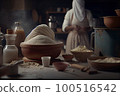 a woman in the kitchen with flour, milk and other food items on the table next to her she is wearing a white robe 100516542