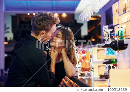 At the bar. Happy young couple is together on their vacation 100518389