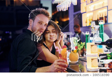At the bar. Happy young couple is together on their vacation 100518390