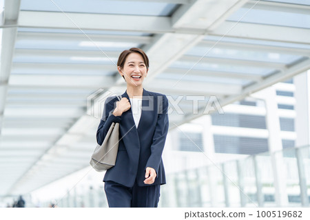 Business woman walking outdoors Business woman walking outdoors 100519682