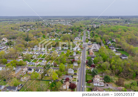 Small american town residential complex district an houses and roads on aerial panoramic view with spring trees landscape Small american town residential complex district an houses and roads on aerial panoramic view with spring trees landscape 100520537