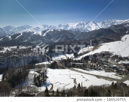 Magnificent early spring at Tsugaike Kogen Ski Resort and the Shirouma mountain range, Otari Village, Nagano Prefecture (aerial photography by drone) 100520755