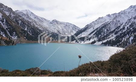 A mountain lake with blue water in winter A mountain lake with blue water in winter 100523898
