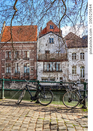 Parked bikes along a canal in the medieval city of Ghent in the Flemish region of Belgium. Travel concept. High quality photo Parked bikes along a canal in the medieval city of Ghent in the Flemish region of Belgium. Travel concept. High quality photo 100525644