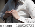 A woman buttoning her shirt upper body changing clothes image 100525723