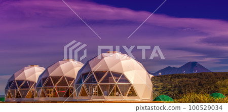 Glamping house on sunset and volcano, rural landscape, tent houses in Kamchatka peninsula 100529034