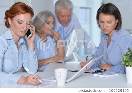 business people colleagues working together in office business people colleagues working together in office 100529195