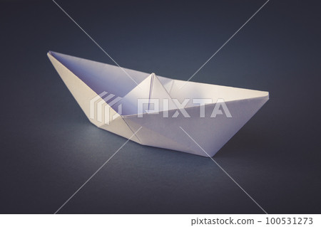 White paper boat origami isolated on a grey background White paper boat origami isolated on a grey background 100531273
