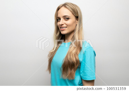 european young woman in a blue tank top on a white background with free space european young woman in a blue tank top on a white background with free space 100531359