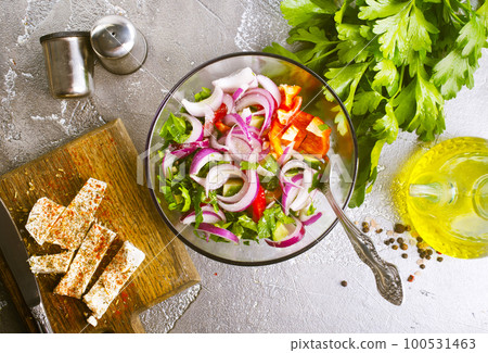 greek salad in bowl, salad with vegetables and cheese on board 100531463