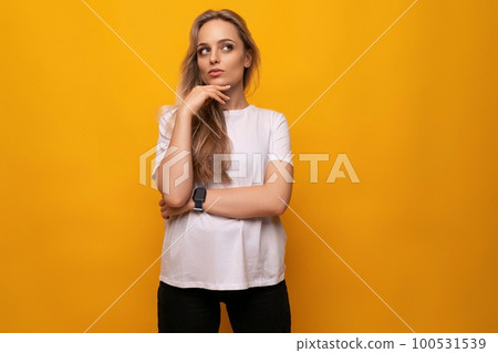 horizontal photo of pensive dreamy girl with blank space on yellow background horizontal photo of pensive dreamy girl with blank space on yellow background 100531539