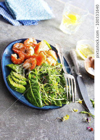 Buddha bowl with soft boiled egg, avocado, greens, grilled shrimps and sauce. Lunch bowl. Buddha bowl with soft boiled egg, avocado, greens, grilled shrimps and sauce. Lunch bowl. 100531640