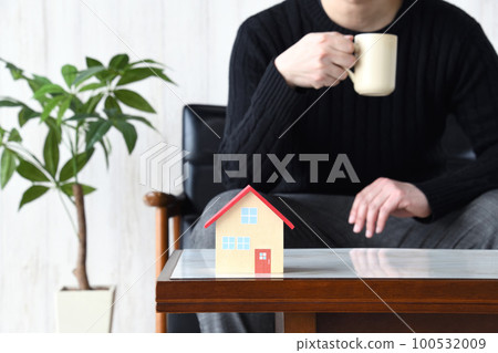 A model of a house and a man drinking coffee - Relaxing image in my home A model of a house and a man drinking coffee - Relaxing image in my home 100532009