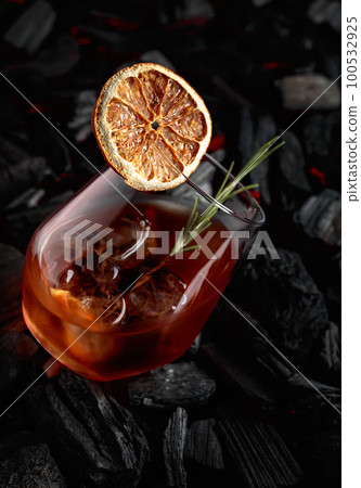 Old-fashioned cocktail with whiskey, ice, orange, and rosemary. Old-fashioned cocktail with whiskey, ice, orange, and rosemary. 100532925
