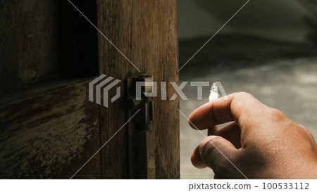 Closeup hand smoking, unhealthy lifestyle concept 100533112