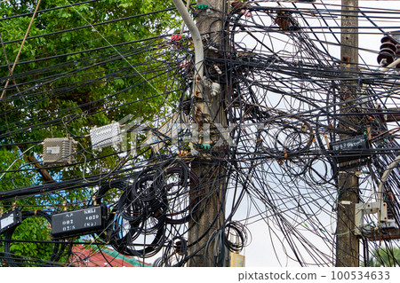 Tangled electrical wires in Thailand. 100534633