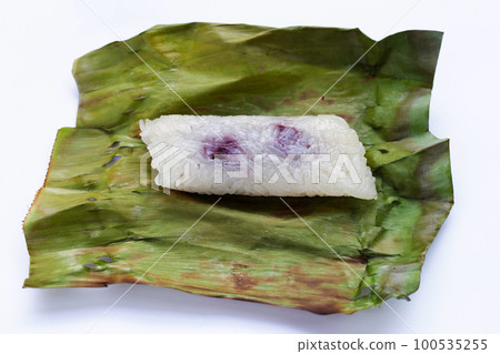 Grilled sticky rice in banana leaves with banana filling Grilled sticky rice in banana leaves with banana filling 100535255