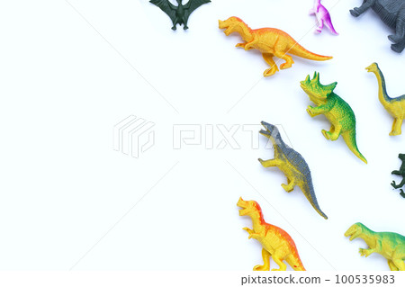 Plastic dinosaur toys on white background. Top view 100535983