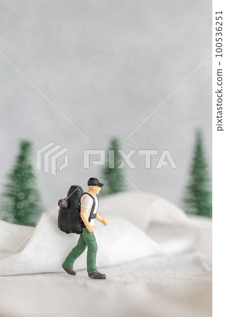 Miniature people Backpacker Travel in winter time Miniature people Backpacker Travel in winter time 100536251