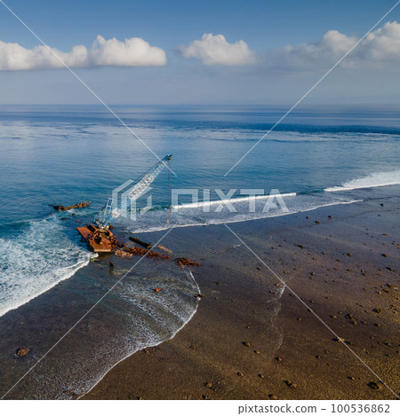 Aerial view of abandoned construction crane over the sea 100536862