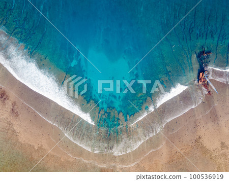Aerial view of Sea waves reaching tropical beach landscape 100536919