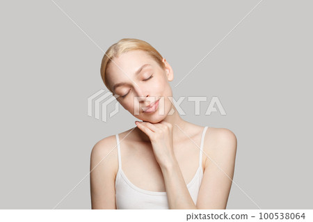 Portrait of gorgeous woman touching her cheek  100538064