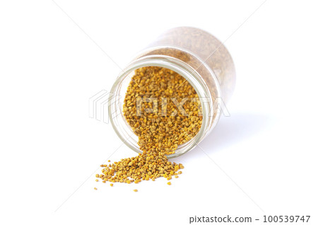 Bee pollen granules crumbled from glass jar 100539747