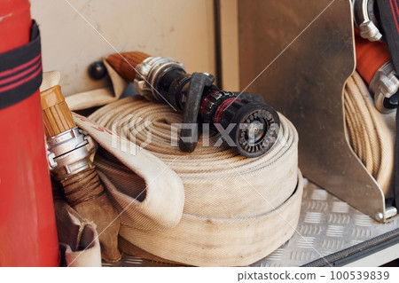 Close up view of hose inside of fire truck. Metal construction 100539839