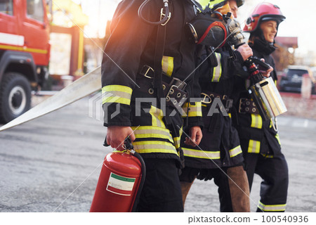 Group of firefighters in protective uniform that is on station Group of firefighters in protective uniform that is on station 100540936