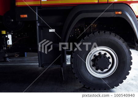 Close up view of red modern fire truck. Side part of vehicle Close up view of red modern fire truck. Side part of vehicle 100540940