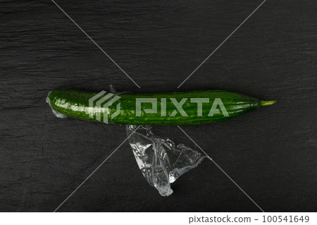 Plastic Wrapped Cucumber, Vegetable in Film Packaging, Film Wrap Food, Eat Plastic Concept Plastic Wrapped Cucumber, Vegetable in Film Packaging, Film Wrap Food, Eat Plastic Concept 100541649