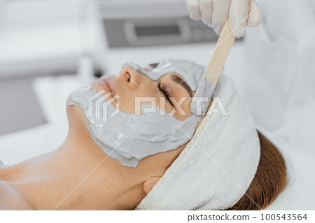 Cosmetic beauty mask for face in beauty salon. Spa procedures, relaxation and skin care. Cosmetic beauty mask for face in beauty salon. Spa procedures, relaxation and skin care. 100543564