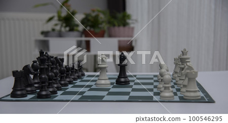 chess pieces on the white surface..Game of Chess. Close Up Playing Chess Game , Success Strategy. chess pieces on the white surface..Game of Chess. Close Up Playing Chess Game , Success Strategy. 100546295