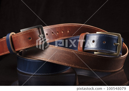 Leather belts on a black background. Haberdashery. 100548079