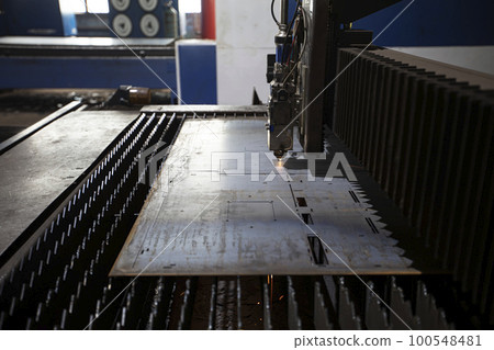 Cutting of metal. Sparks fly from laser.Laser cutting machine working with sheet metal with sparks at factory, plant. Cutting of metal. Sparks fly from laser.Laser cutting machine working with sheet metal with sparks at factory, plant. 100548481